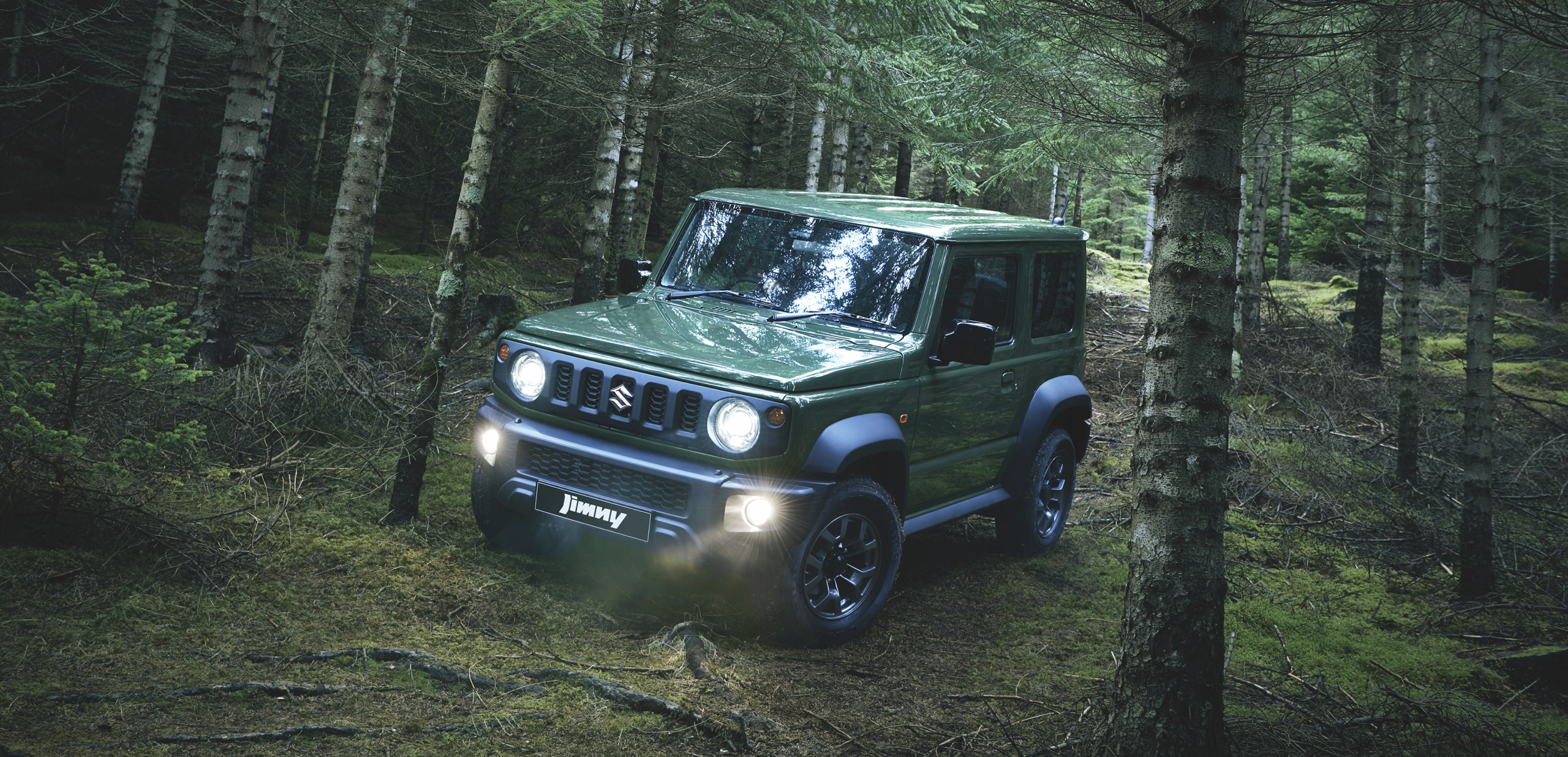 Suzuki Jimny Dark Green in a Pine Forrest
